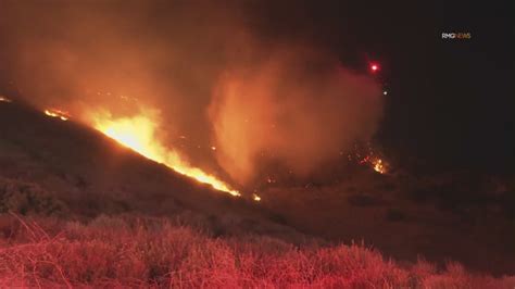 Fire crews work to contain overnight brush fire in San Fernando Valley amid Santa Ana winds 